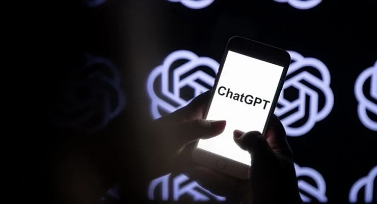 Bir kişinin tuttuğu telefonda ChatGPT yazısı, arka planda ChatGPT logoları görülüyor