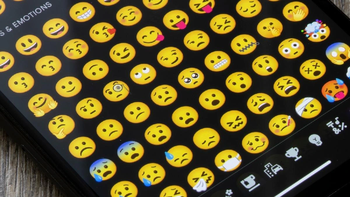 Akıllı telefon ekranında farklı yüz ifadelerini gösteren emoji klavyesi