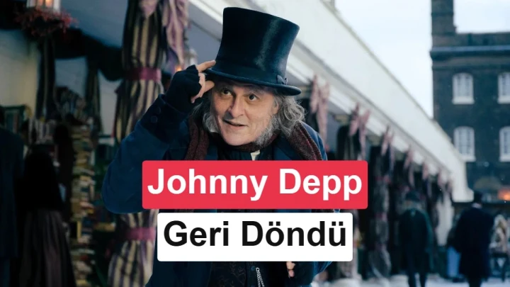 Johnny Depp, Ebenezer Scrooge kostümüyle silindir şapkasını tutarken