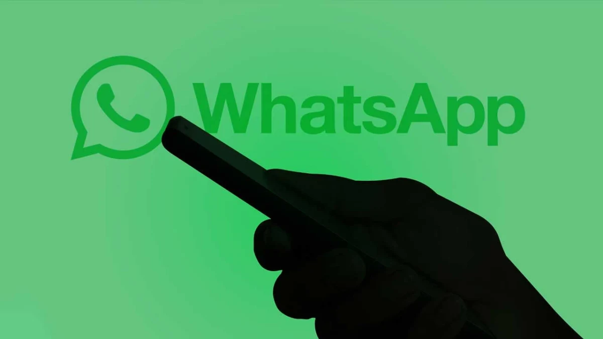 WhatsApp logosunun önünde, ekrana dokunan bir elin silüeti